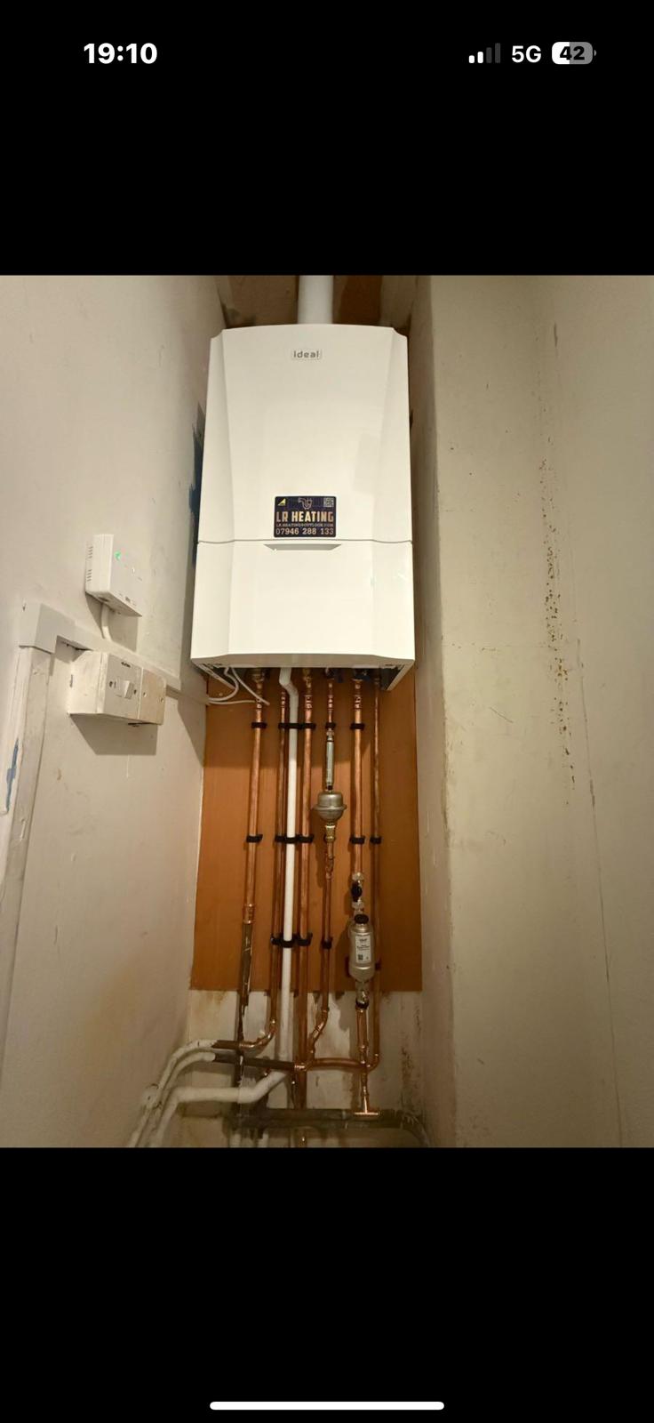 New combi boiler mounted on a copper pipework backboard by LR Heating, Leeds
