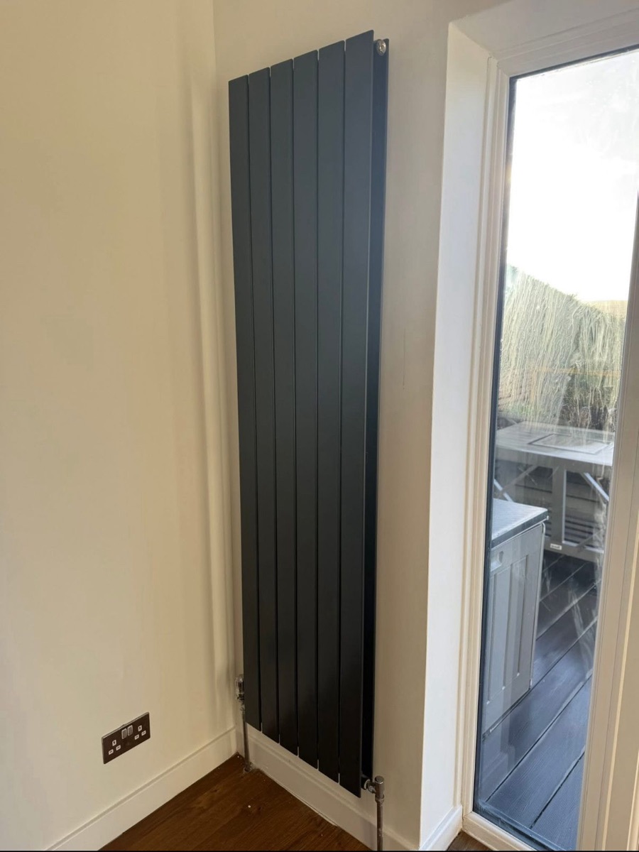 Anthracite vertical designer radiator fitted beside patio doors by LR Heating, Leeds