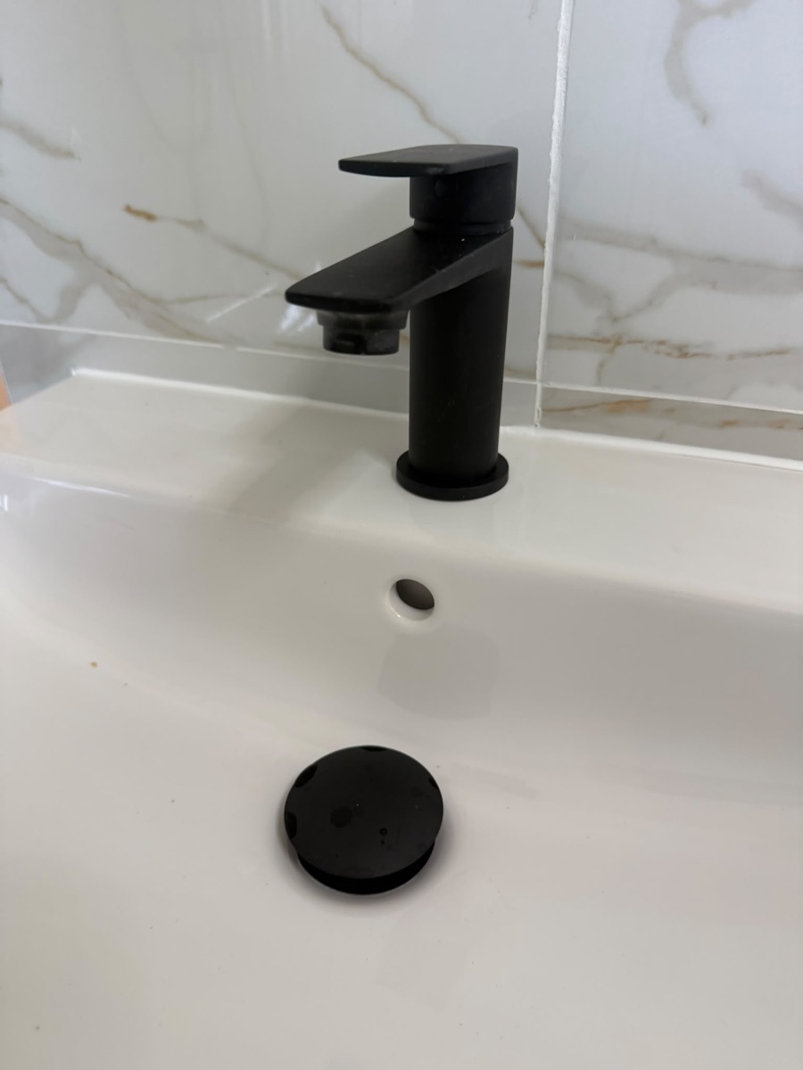 Matt-black basin tap fitted on a white basin in a bathroom refit by LR Heating